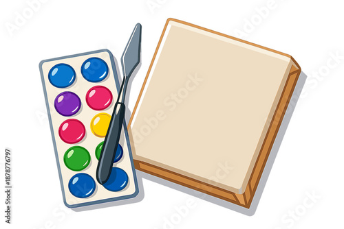 Colorful watercolor paint set with palette knife and blank canvas for artistic creation