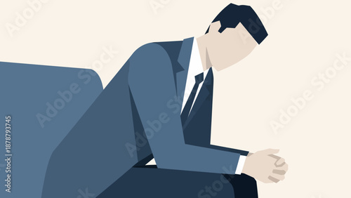 Young businessman in a suit sits thoughtfully with his head down, contemplating his next move in a business setting or during personal reflection