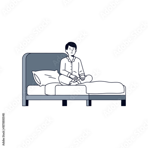 Man sits on bed in a meditative pose with eyes closed in a bedroom