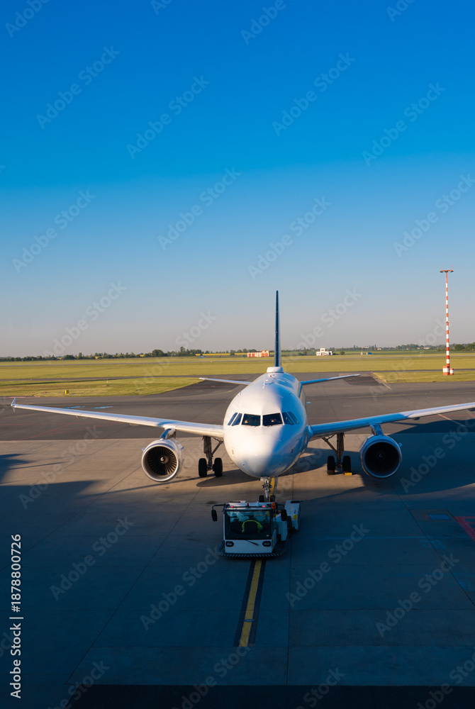 Naklejka premium Passenger airplane taxiing on the runway of a modern international airport.