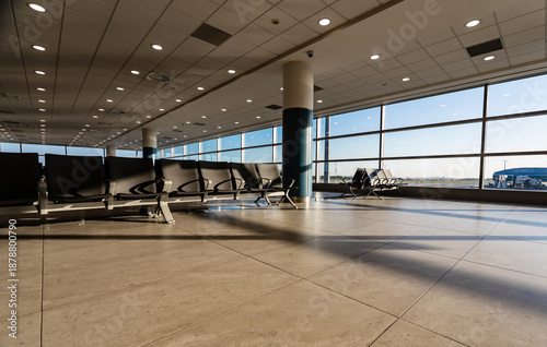 Empty waiting area with seats in a modern international airport terminal.