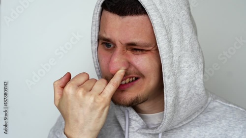 The disgusting and vile habit of picking one's nose.
A man fell asleep with his finger in his nose.
Close-up of a man's finger in his nose.