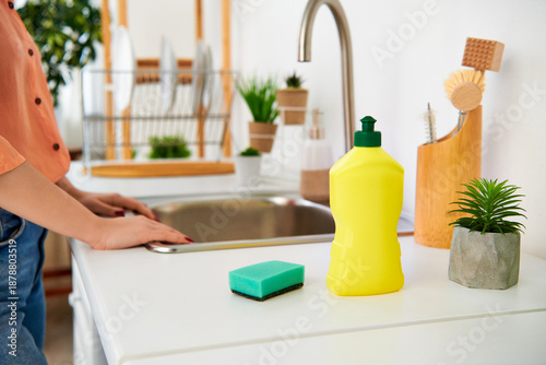 Young woman happily tidies her modern apartment with fun cleaning activities