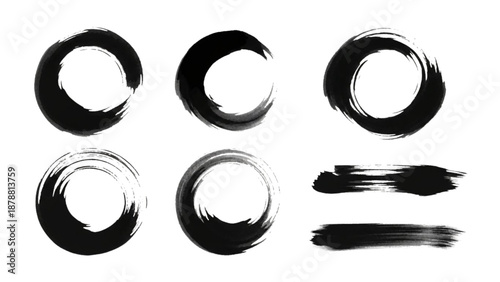 Collection of abstract circular shapes and brush strokes in black ink on a plain background viewed from directly above