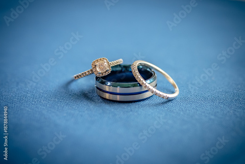 Side View of Blue and White Gold Diamond Wedding Rings on Blue Fabric