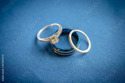 Top View of Blue and White Gold Diamond Wedding Rings on Blue Fabric