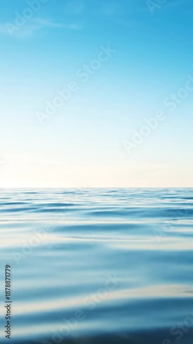 Rippling blue ocean surface under a vast, bright blue sky with a clear horizon