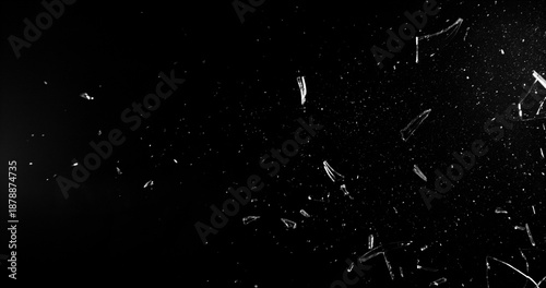 Slika na platnu Side angle photo of flying shattered glass shards and dust isolated on black background