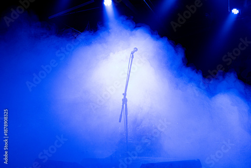 microphone on stage, smoke and blue light, no people, backlight