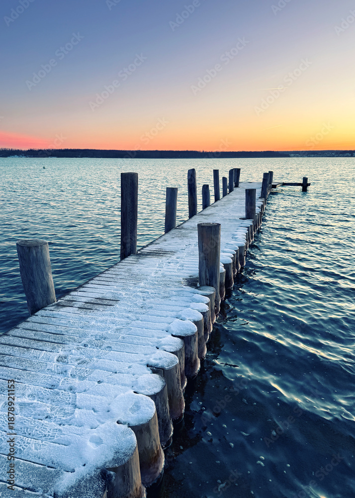Fototapeta premium frozen wooden pier on the beach in winter season