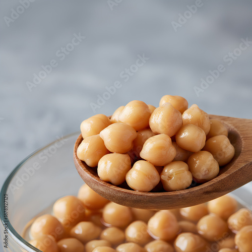 Wallpaper Mural Healthy boiled chickpeas being served with a wooden spoon, essential vegan ingredient for hummus and Mediterranean salads, high-fiber legumes in a glass bowl with soft natural lighting and copy space Torontodigital.ca
