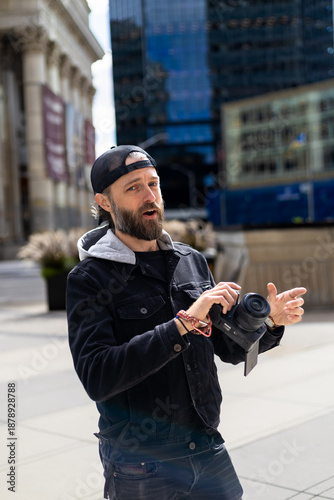 Bearded man taking photos in downtown city