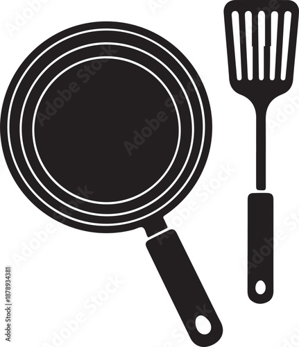 Black frying pan and spatula kitchen utensils cooking