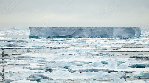 Broken sea ice surrounds a large tabular iceberg in the South Scotia Sea.