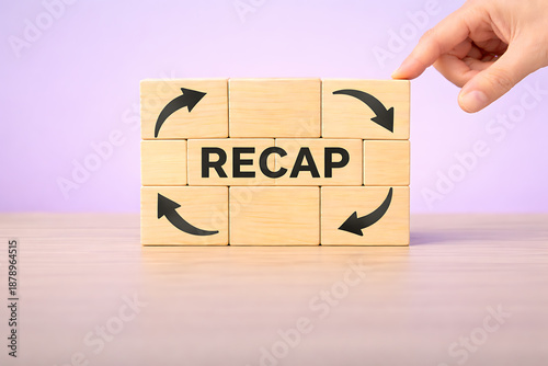 Business recap and performance review concept with circular arrows and recap text on wooden blocks