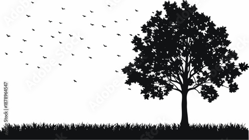 Serene landscape with tree silhouette and birds in flight at dusk