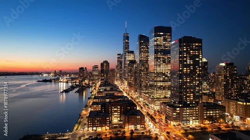 City skyline silhouette shimmers at twilight reflecting in calm waters