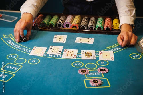 Bild auf Leinwand Casino Dealer Dealing Cards at Poker Table with Chips
