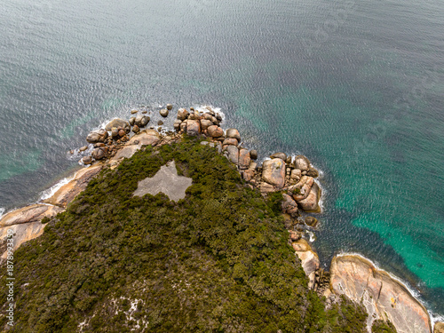 Coastal headland with rocky shoreline and clear water