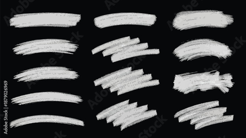 A striking collection of various white chalk and paint brush strokes, along with energetic scribbles on a dark black background, creating a bold, contrasting texture.