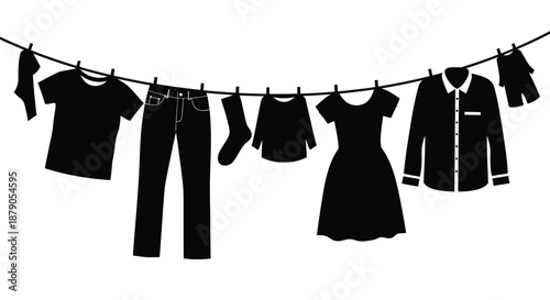 A collection of clothes hanging on a clothesline against a white background