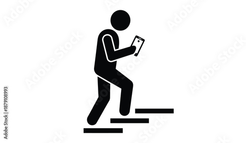 A person walking up stairs while looking at a mobile phone