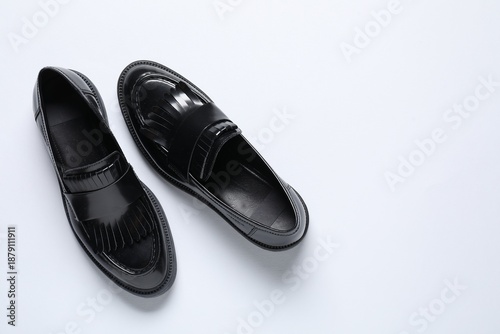 Fotografija Pair of stylish black loafer shoes on white background, top view