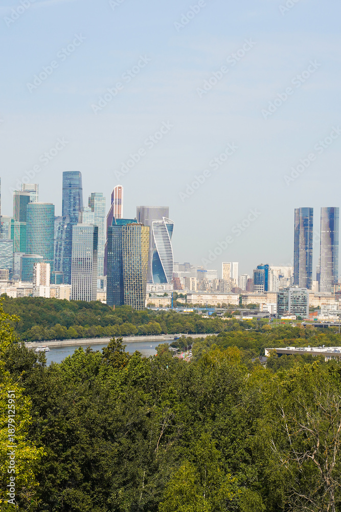 Fototapeta premium Moscow financial district view on a sunny summer day, Russia. Travel destinations and sightseeing viewpoint on the Vorobyevy Hills near the Moscow State University historical building