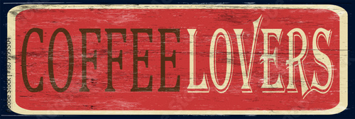 Aged and worn coffee lovers sign on wood