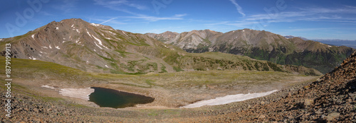 Photos This Colorado mountain panorama features 14ers Mount Harvard, Mount Belford, and Mount Oxford rising above a partially frozen tarn