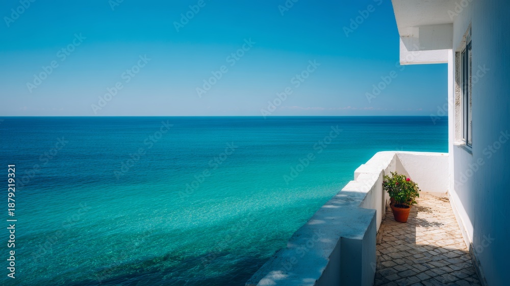 Fototapeta premium Relaxation on a hotel balcony overlooking turquoise water and clear sky with modern terrace design for vacation enjoyment