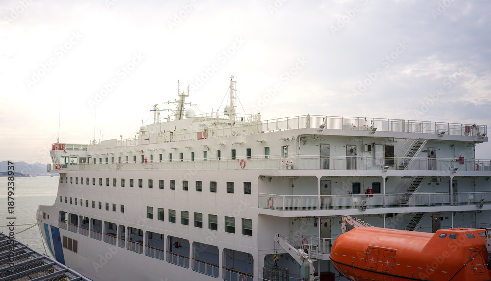 Naklejka premium Large white passenger ship docked at the pier