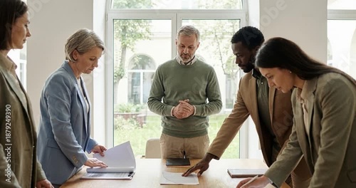 Business team meeting around table in bright office space