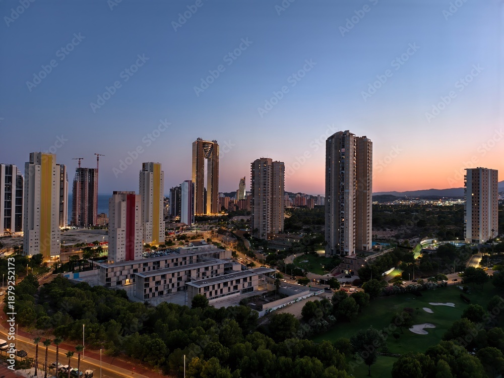 Fototapeta premium colorful coastal sunset skyline, tranquil sunset over housing towers and vibrant horizon silhouettes