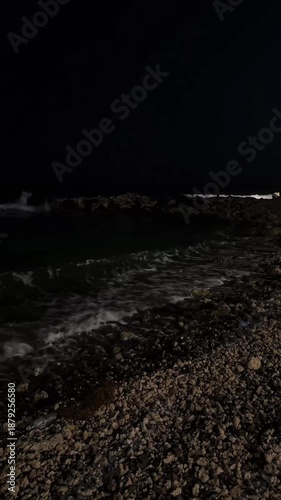 Dark Night Ocean Waves Crashing on Rocky Shore