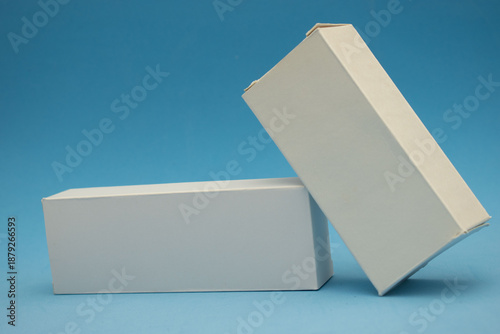 Minimal cosmetic packaging mockup with white boxes and luxury pearls on pastel background