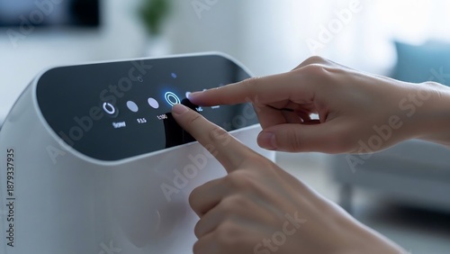 Person operating a modern air purifier with a touch control panel in a bright living room.