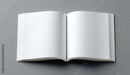 Open blank hardcover book with smooth white pages on a neutral gray background for mockup presentations