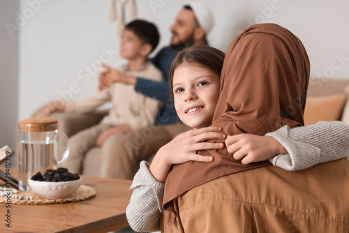 Muslim girl hugging her mot...