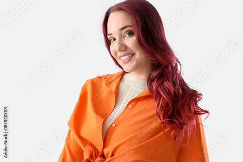 Young woman with curly red ...