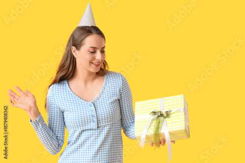 Young woman in party hat wi...