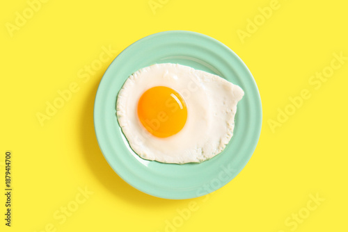 Plate with tasty fried egg ...