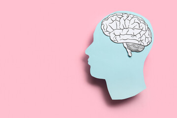 Paper human head with brain on pink background. World Mental Health Day