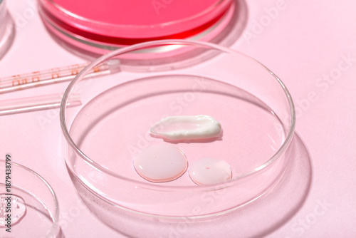 Petri dishes with samples on pink background