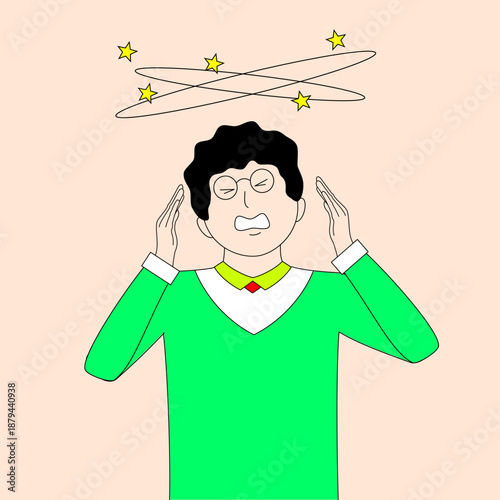 A man in a green shirt is holding his head and looking at the camera