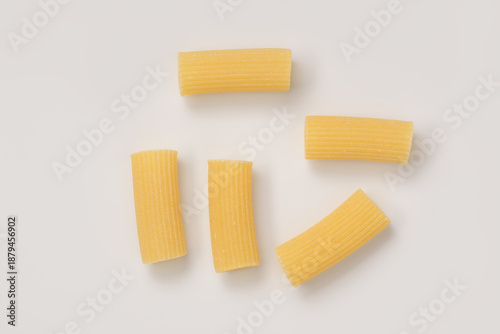 Tableau sur toile Italian dry rigatoni pasta over white background with shadow top view