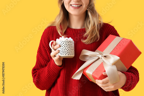 Young woman holding cup of ...