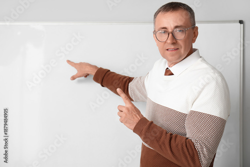 Male teacher with laptop po...
