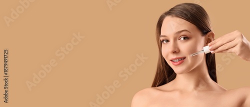 Young woman applying facial...