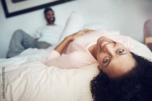 Portrait, happiness and woman in bedroom, man and relationship with love, morning and rest. House, couple and marriage with weekend break, trust and bonding together with care, relax and upside down